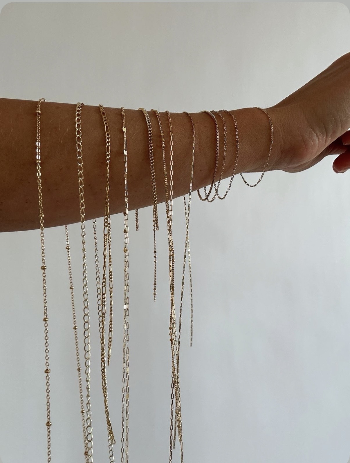 Many chain styles draped from an arm
