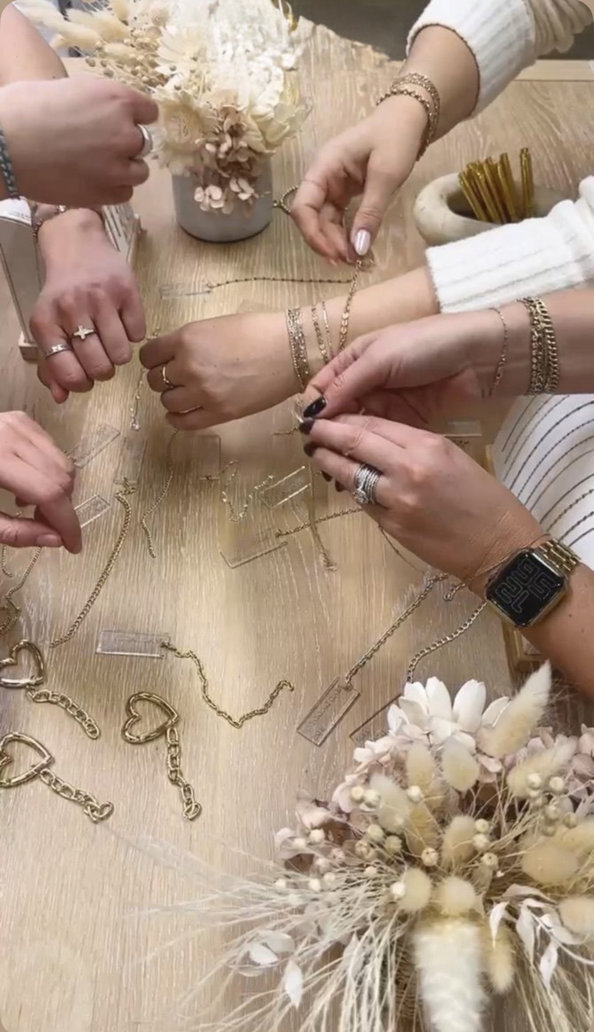 Friends comparing jewelry chains at a gathering